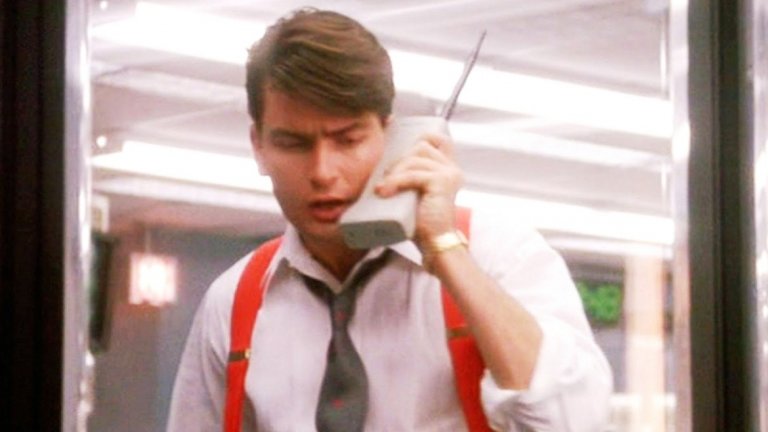 5. Първите мобифони
"Шефе, търсят те по мобифона" не е само начална реплика от една доста стара песен, но и описание за времена, в които мобилният телефон беше рядкост - символ на престиж, а в някои случаи и на дълбоки джобове заради не особено легален бизнес. Днес мобилните телефони са навсякъде около нас, поради което не можем да оценим истински революцията, която представляват. Първият мобилен телефон, който може да бъде държан в ръка, е представен от Motorola през 1973-а и тежи цели 2 килограма. Опитайте се да държите бутилка с газирана напитка до ухото си 5 минути и вероятно ще пресъздадете усещането. Мобифонът беше гъзарски аксесоар не само у нас, но навсякъде по света - иконични са кадрите на Майкъл Дъглас с неговия телефон във филмовата класика "Уолстрийт" (на снимката: героят на Чарли Шийн също се възползва от "удобствата" на мобилната комуникация).