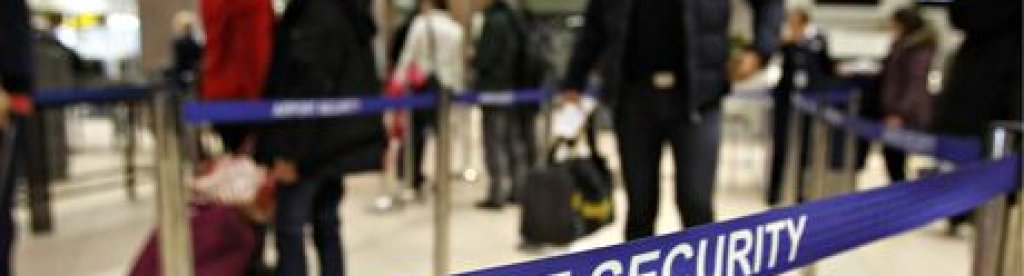 Romanians pass through airport security for a flight to Heathrow airport in Britain