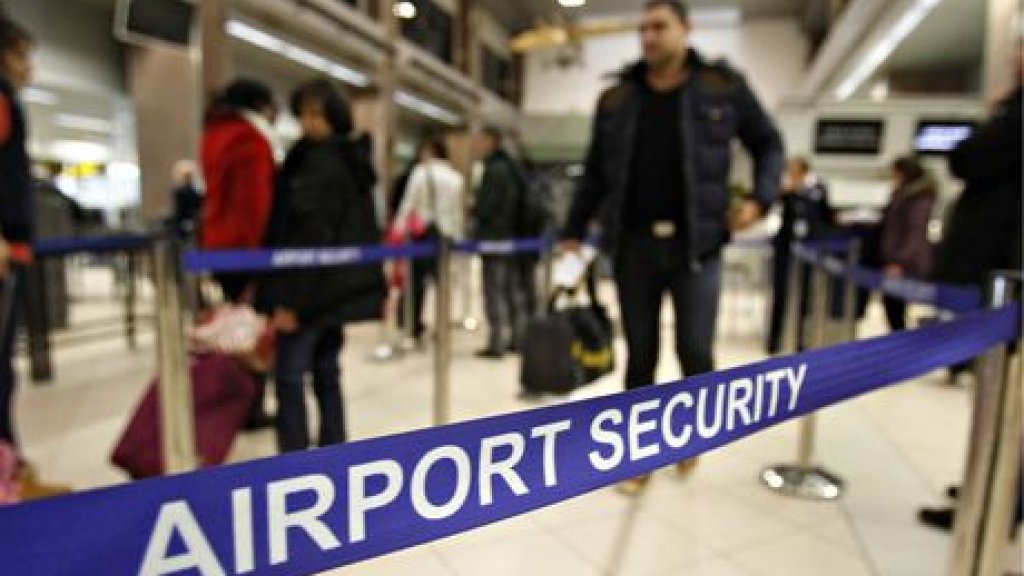 Romanians pass through airport security for a flight to Heathrow airport in Britain