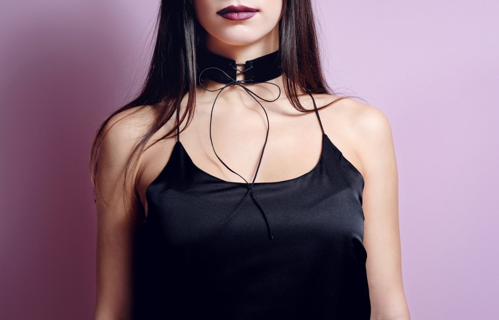 Fashion portrait woman black velvet choker lace up. Close up
