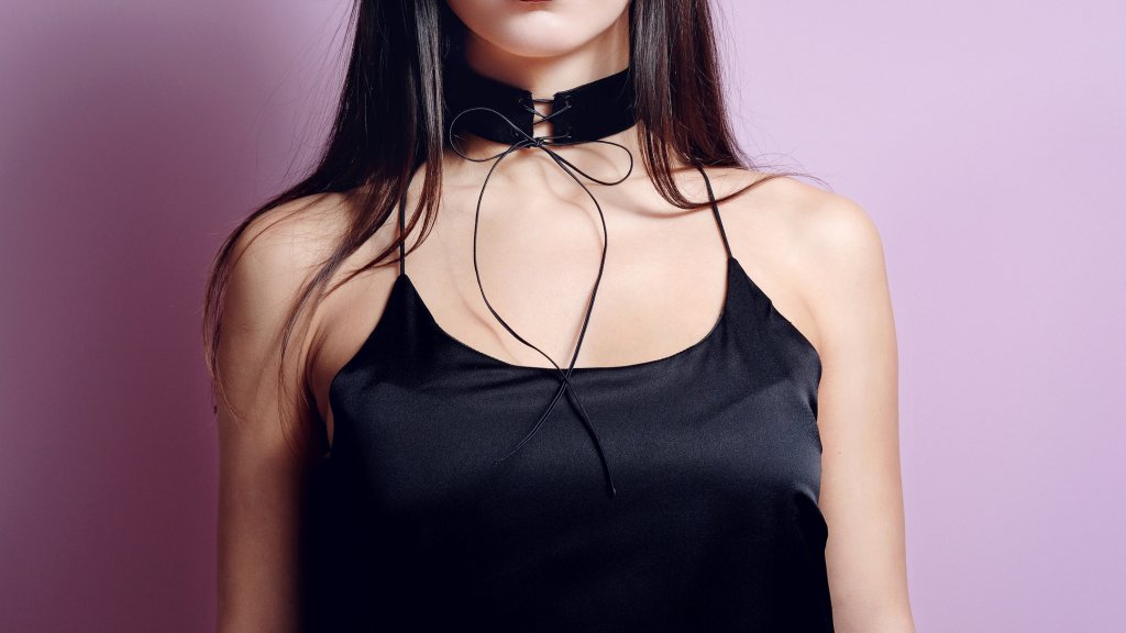 Fashion portrait woman black velvet choker lace up. Close up