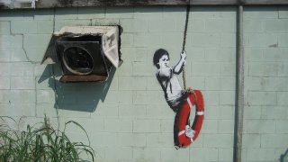 1280px-Banksy_Swinger_Building_Detail