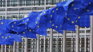 European Union flags outside the European Commission headquarters in Brussels