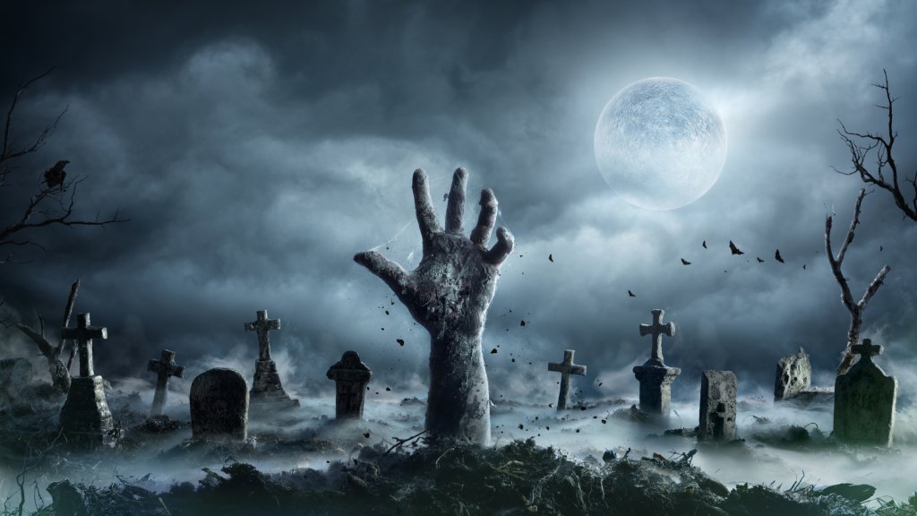 Zombie Hand Rising Out Of A Graveyard In Spooky Night