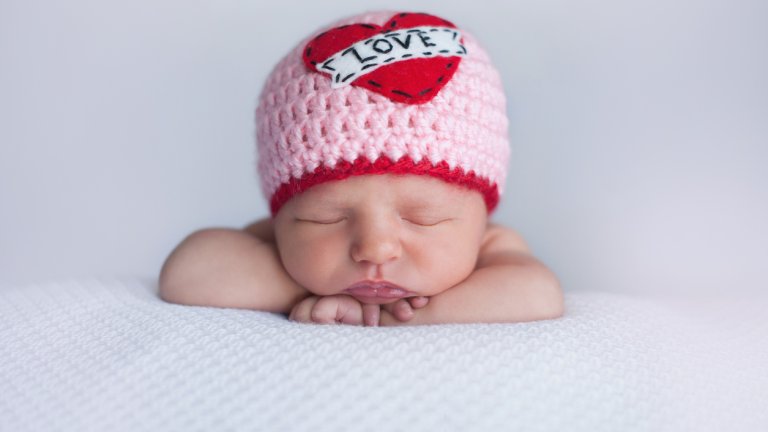 Newborn Baby Girl Wearing a "Love" Hat