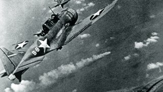 SBD-3_Dauntless_bombers_of_VS-8_over_the_burning_Japanese_cruiser_Mikuma_on_6_June_1942