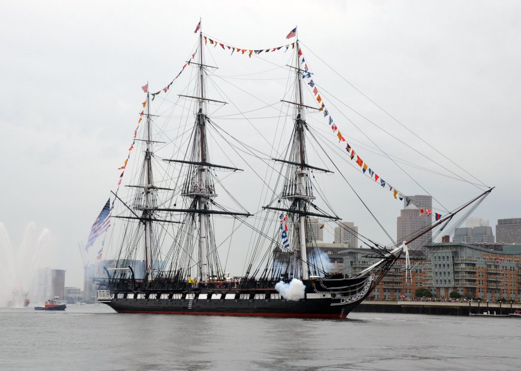 USS Constitution fires a 17-gun salute.