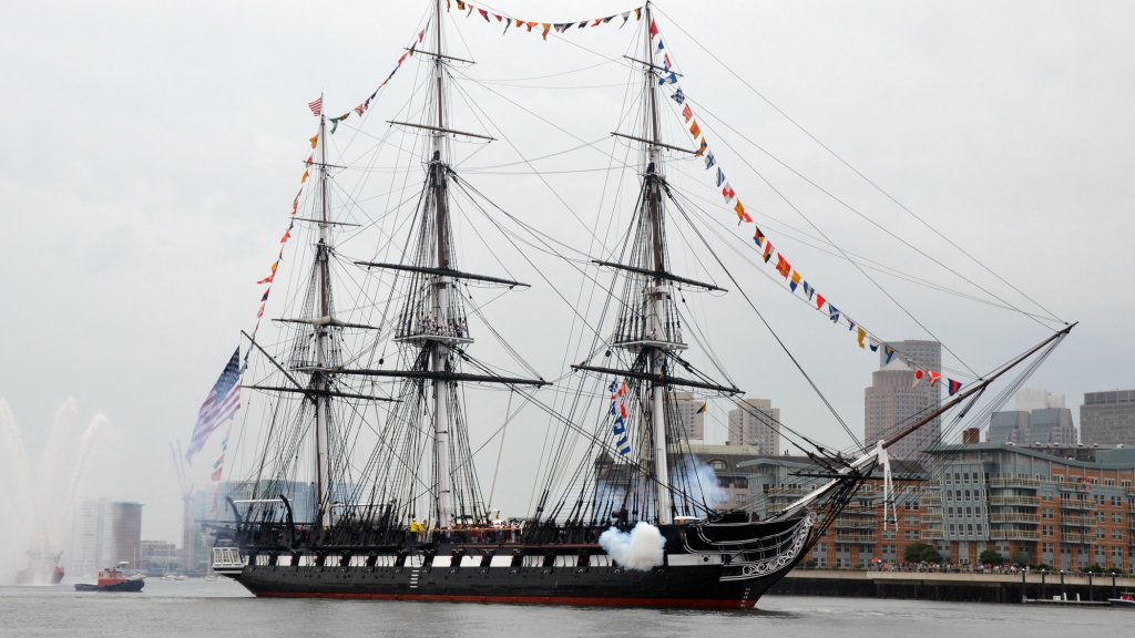 USS Constitution fires a 17-gun salute.
