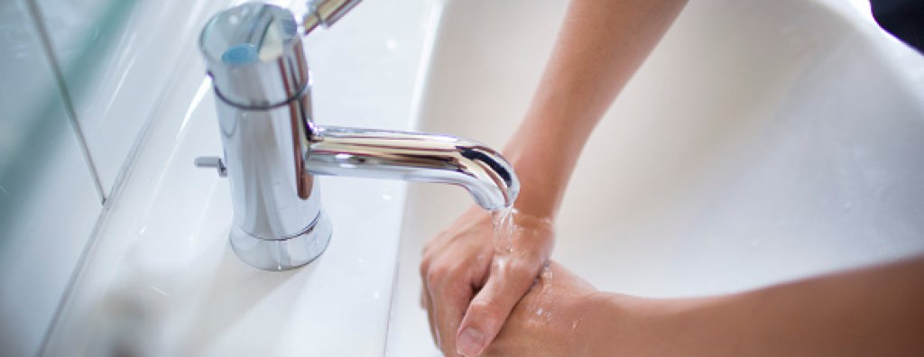Teenaged Boy Washing His Hands