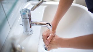 Teenaged Boy Washing His Hands