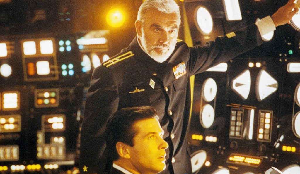The Hunt for Red October / ”На лов за Червения октомври”
Истински класически екшън трилър, който акцентира на интелекта, логиката, интуицията и политическата гъвкавост за сметка на силата. Основна заслуга има режисьорът Джон Мактиърнън, който успява съвсем гладко и разбираемо да адаптира за големия екран сложния стил на писане на Кланси. Естествено, важна роля за успеха на филма имат и двамата актьори в главните роли - Алек Болдуин, който изиграва култовия агент на ЦРУ Джак Райън, и Шон Конъри, на който даже шотландския акцент не му попречи да се превъплъти в ролята на съветския капитан-беглец Марко Рамиус. Че даже и получи номинация за “Оскар” за нея.