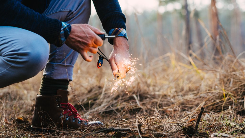 A man makes a fire with a flint