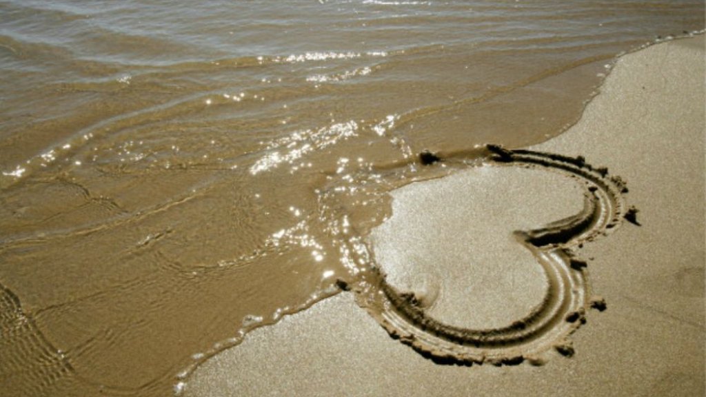 150756784-painted-heart-in-the-sand-gettyimages