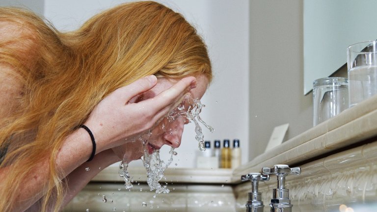 Woman washing her face