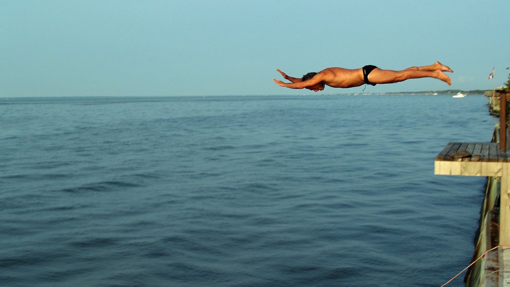 1280px-Diving_off_a_deck_into_the_Great_South_Bay_of_Long_Island
