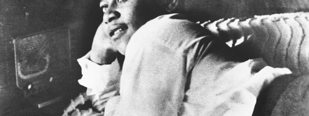 Emmett Till is shown lying on his bed.