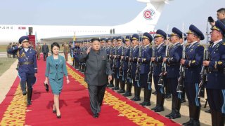 North Korean leader Kim salutes upon arriving for the 2014 Combat Flight Contest among commanding officers of the Korean People's Air Force