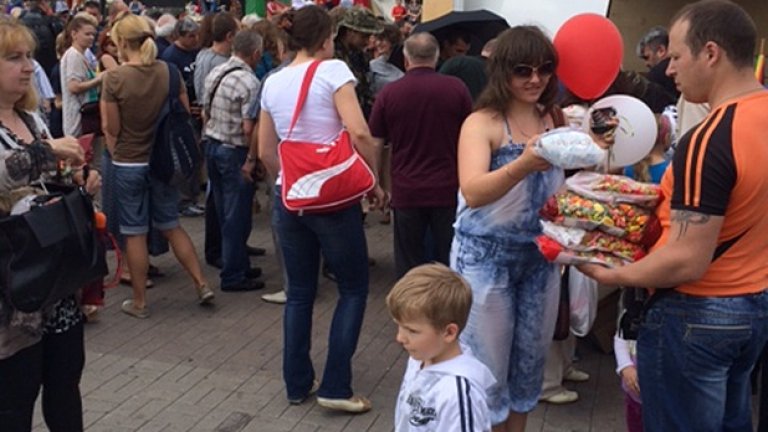 Под зоркия поглед на Владимир Илич Ленин, малко по-рано, бунтовници раздават сладките на децата