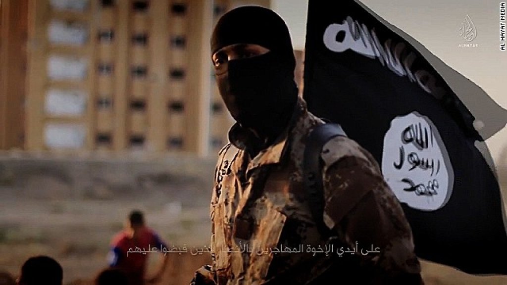 141117103601-isis-masked-militant-flag-story-top
