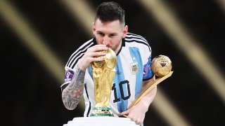 Photo for the story: Lionel Messi - with one hand on the coveted world title and the other holding it "The golden ball" for the best player of the 2022 World Cup.