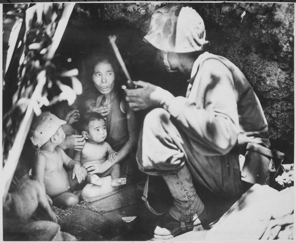 _A_member_of_a_Marine_patrol_on_Saipan_found_this_family_of_Japs_hiding_in_a_hillside_cave._The_mother,_four_children_an_-_NARA_-_532380.tif