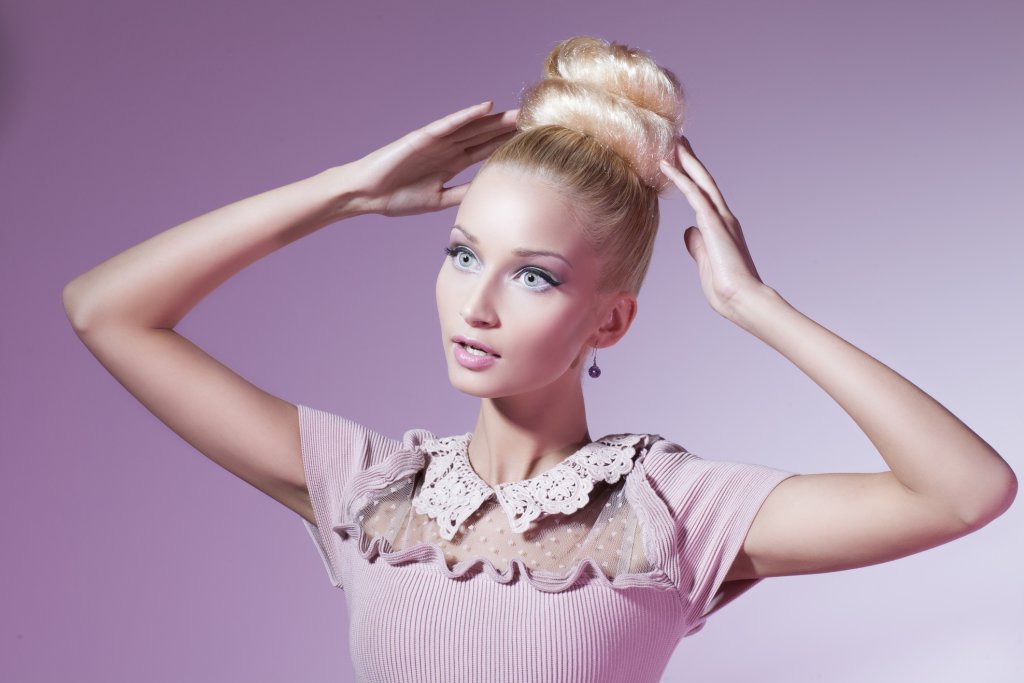 Girl dressed in pink looking like shop mannequin