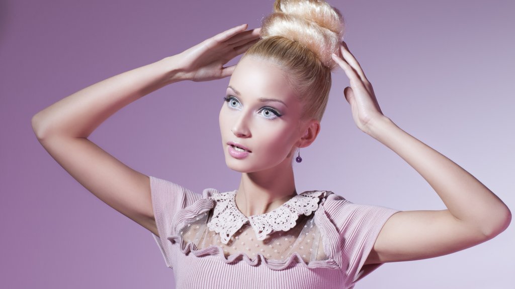 Girl dressed in pink looking like shop mannequin