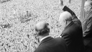 Winston_Churchill_waves_to_crowds_in_Whitehall_in_London_as_they_celebrate_VE_Day,_8_May_1945._H41849