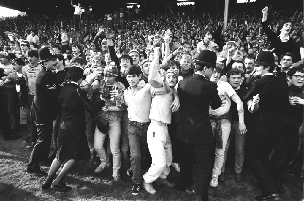 Fans invade pitch.