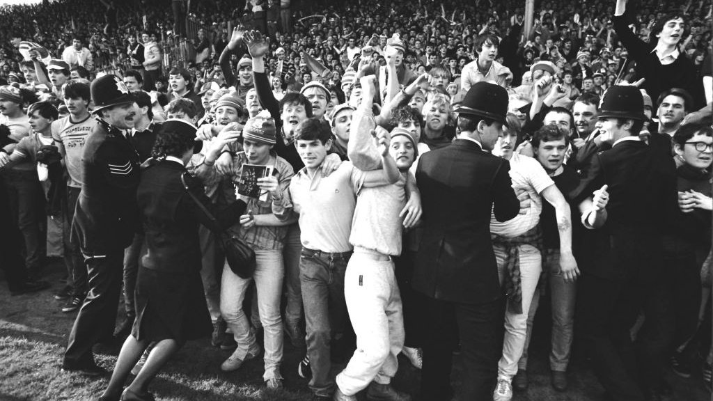 Fans invade pitch.