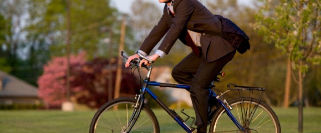 This guy is riding his bicycle to work.