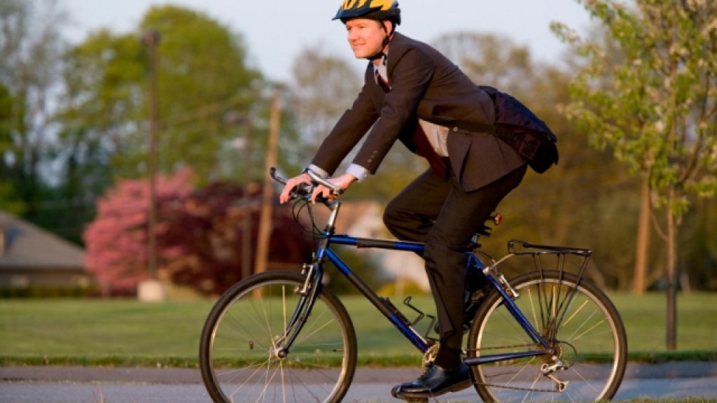 This guy is riding his bicycle to work.