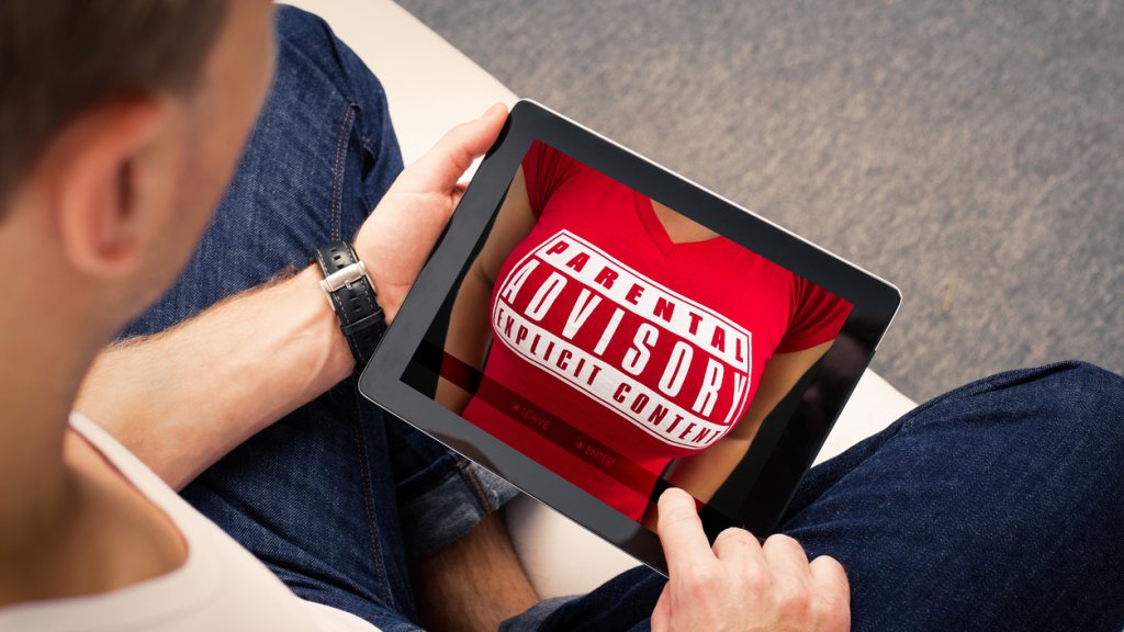 Man looking at adults website on tablet