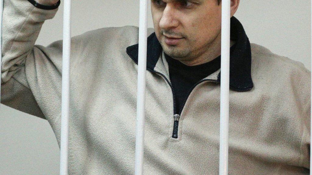 Ukrainian film director Oleg Sentsov (right), was arrested on charges of terrorism last year in Crimea shortly after Russia seized it from Ukraine. He's shown here at a hearing at Moscow's Lefortovo District Court on Dec. 26, 2014.