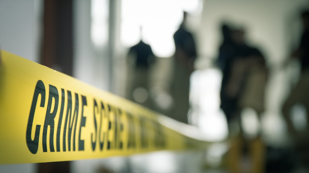 crime scene tape with blurred forensic in cinematic tone
