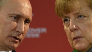 032514putinmerkel2_640x360