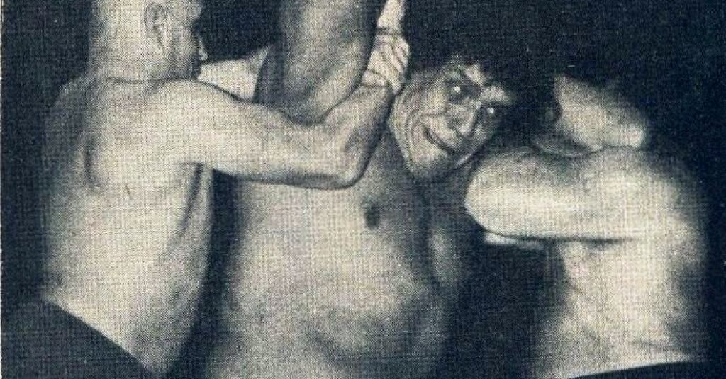 Le_Géant_Ferré_being_hold_by_two_wrestlers_-_Wrestling_Revue_June_1973_page_14_-_André_the_Giant_-_Unwanted_by_my_family,_I_left_home_at_fourteen_(cropped)