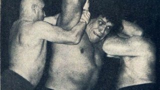 Le_Géant_Ferré_being_hold_by_two_wrestlers_-_Wrestling_Revue_June_1973_page_14_-_André_the_Giant_-_Unwanted_by_my_family,_I_left_home_at_fourteen_(cropped)