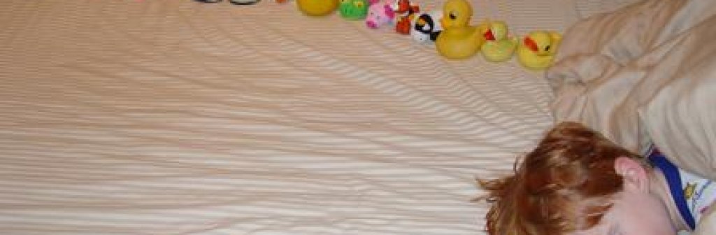 Autistic-sweetiepie-boy-with-ducksinarow