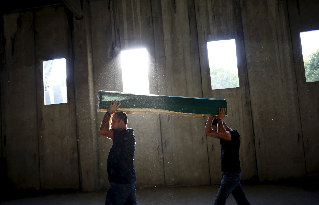 Men carry a coffin containing the body of a newly identified victim of the 1995 Srebrenica massacre at the Memorial Center in Potocari