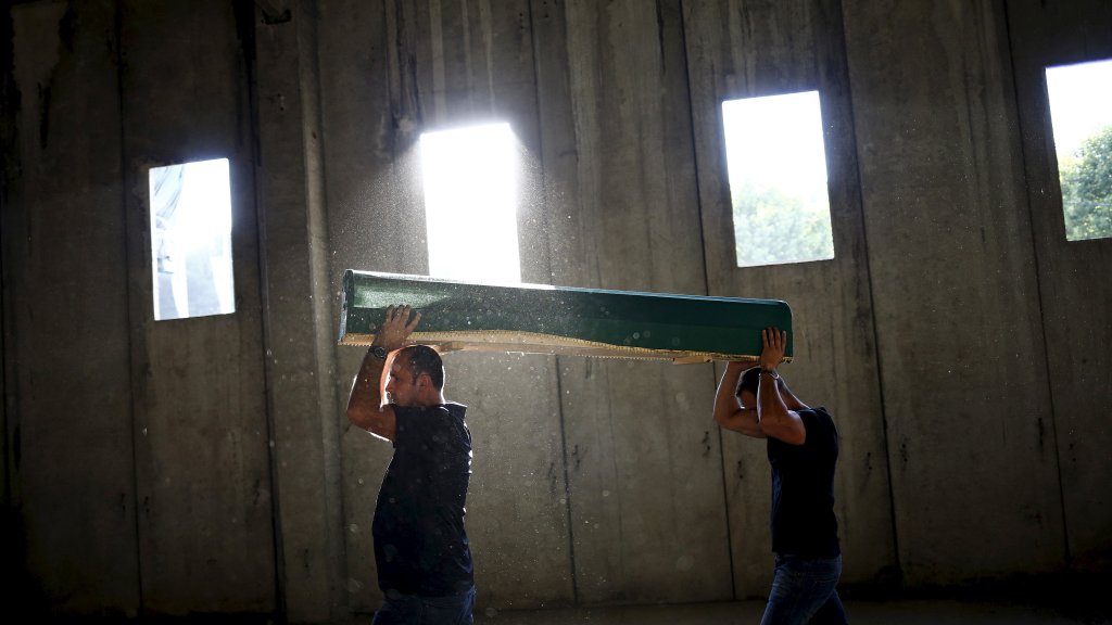 Men carry a coffin containing the body of a newly identified victim of the 1995 Srebrenica massacre at the Memorial Center in Potocari