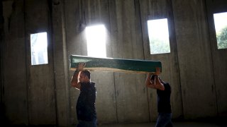 Men carry a coffin containing the body of a newly identified victim of the 1995 Srebrenica massacre at the Memorial Center in Potocari
