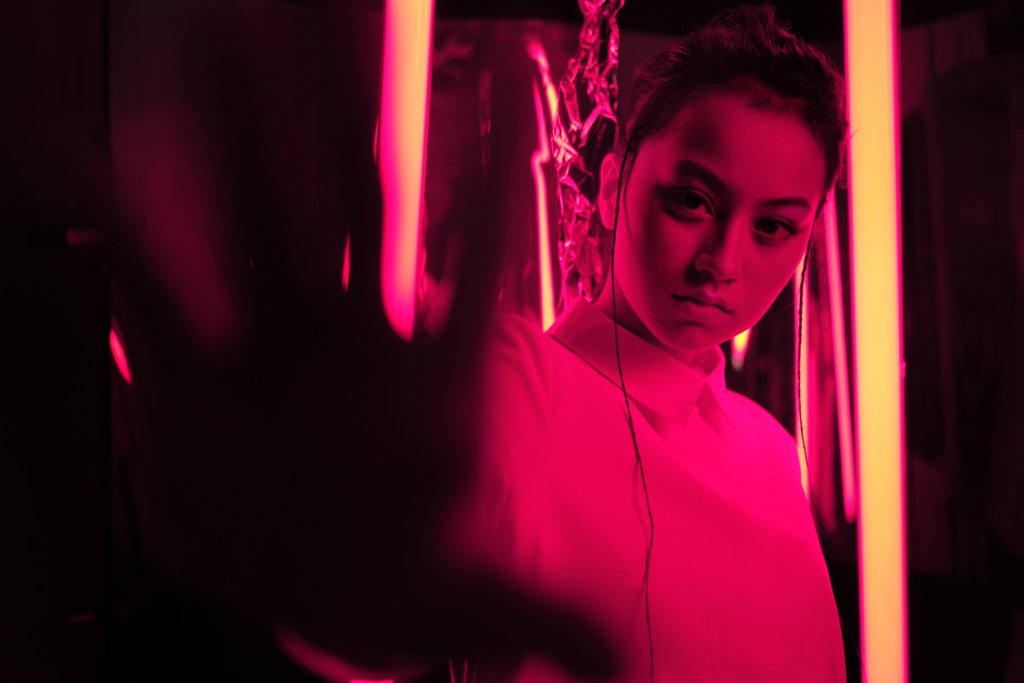 Teenage asian girl in red neon light