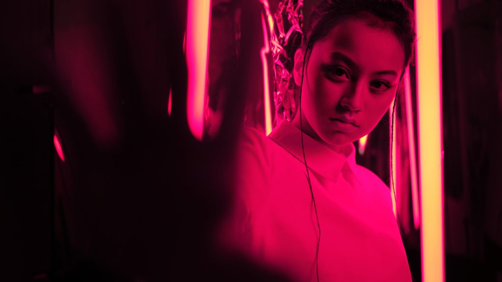 Teenage asian girl in red neon light