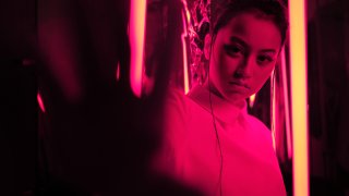 Teenage asian girl in red neon light