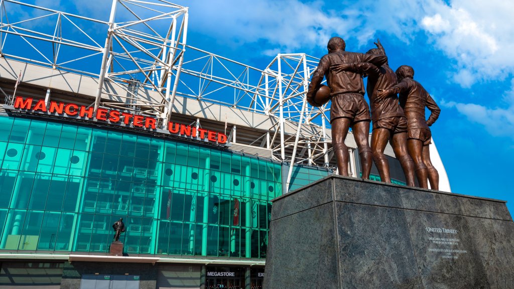 The United Trinity bronze sculpture at Old Trafford stadium in Manchester, UK