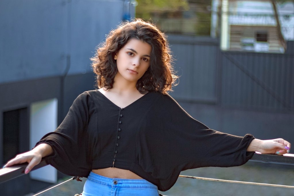 photo-of-a-woman-leaning-on-railings-2535925