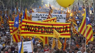 People hold banner reading "independence" during a protest for greater autonomy for Catalonia within Spain in Barcelona