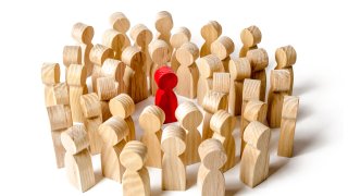 A crowd of people surrounded the red man. Accusation of crime, lynch court. The leader in the center. Angry mob. Attracting new members to the team. General support and mutual assistance.