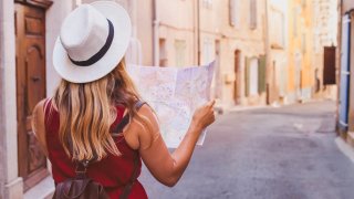 travel to Europe, tourist looking at map on the street, summer holidays